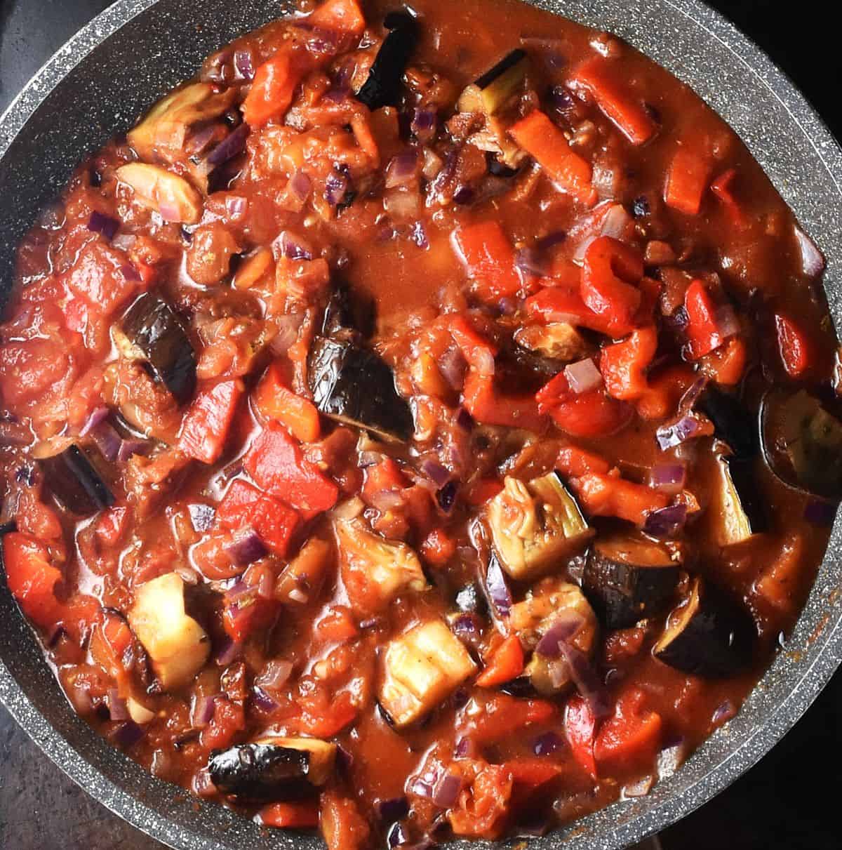 Thick eggplant tomato sauce in large pan.