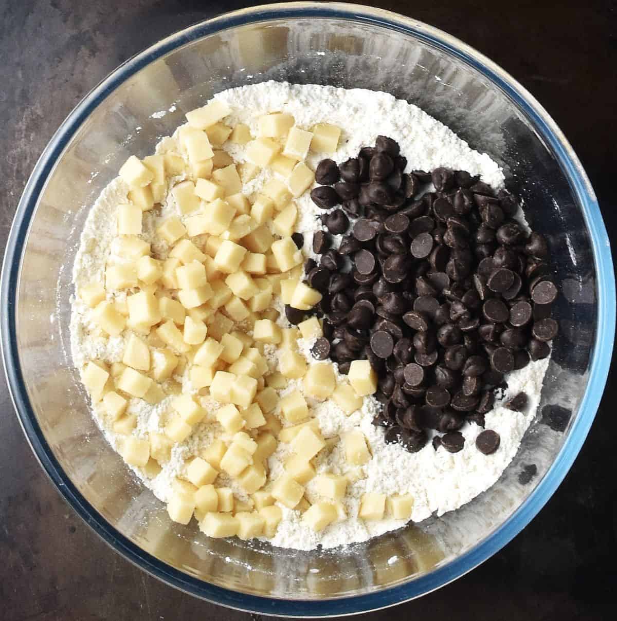 Chopped marzipan ,chocolate chips and flour in glass bowl.