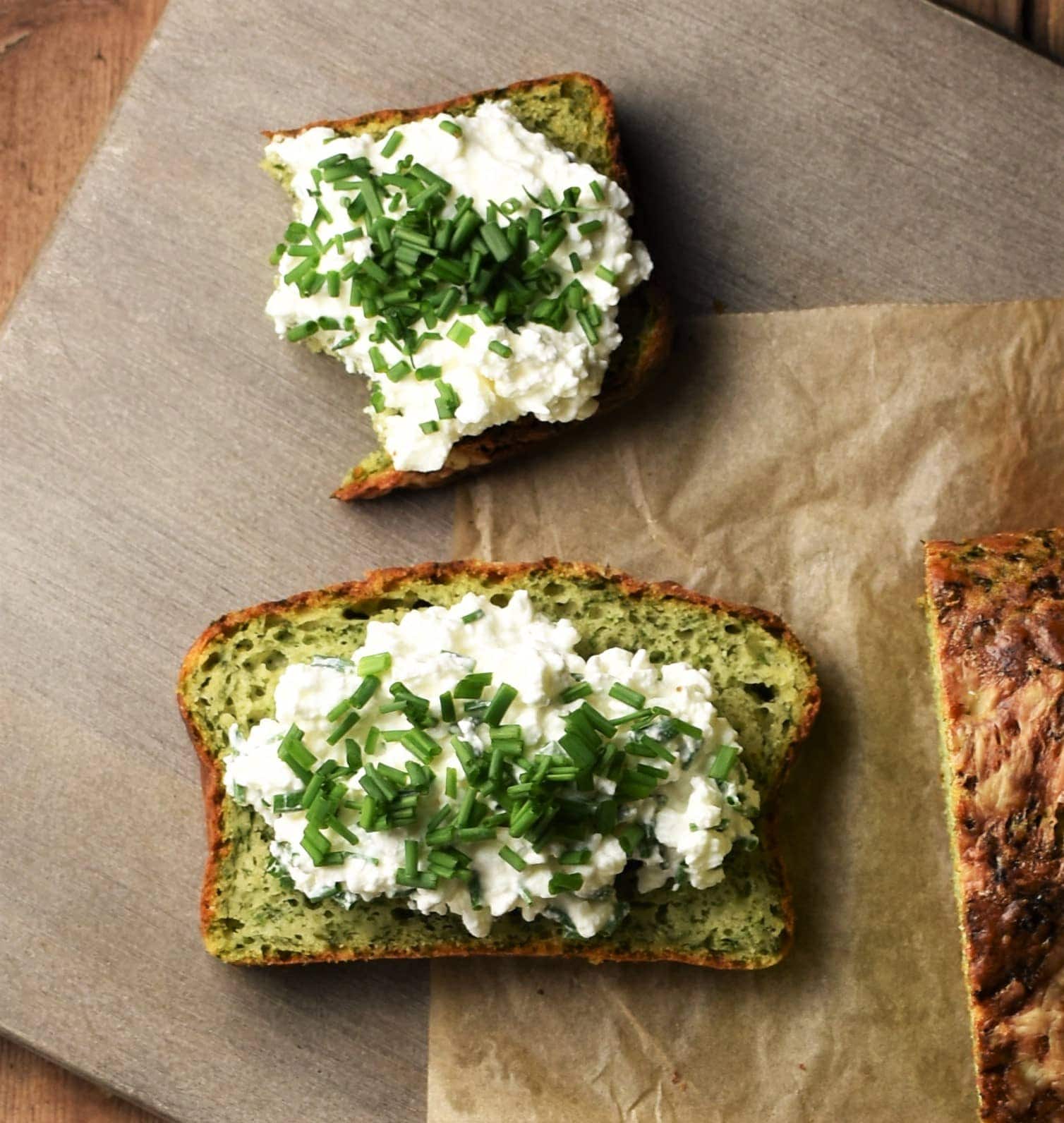 Spinach bread slices topped with cottage cheese and chives.