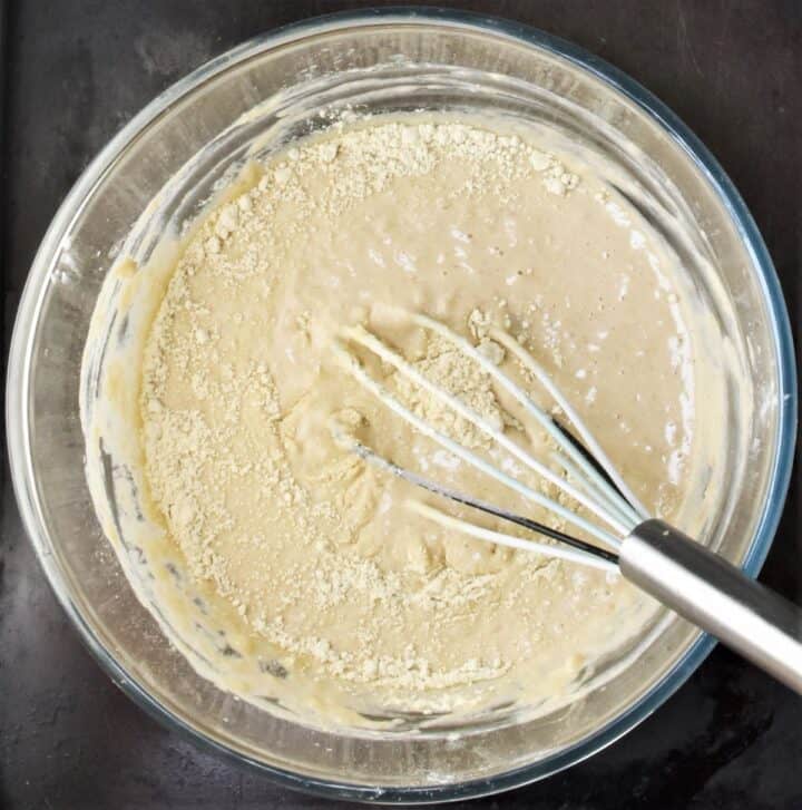 Quinoa pancakes batter with flour and whisk.