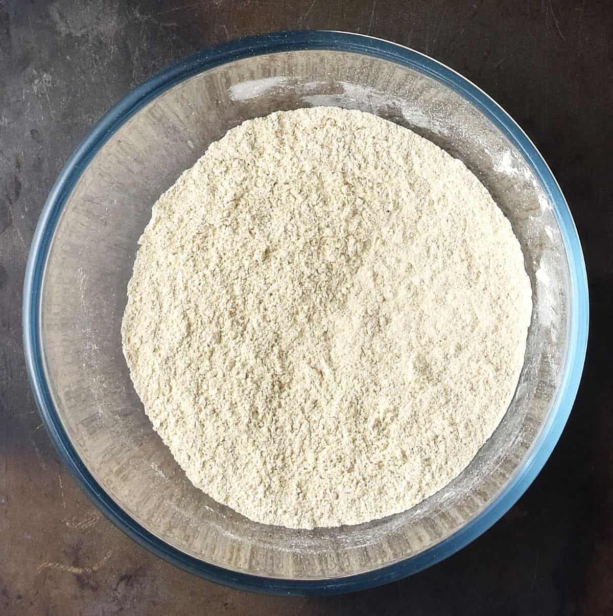 Dry quinoa pancake mixture in glass bowl.
