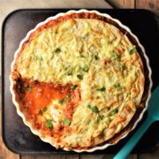 Cut tortilla bake in pie dish with sauce visible.