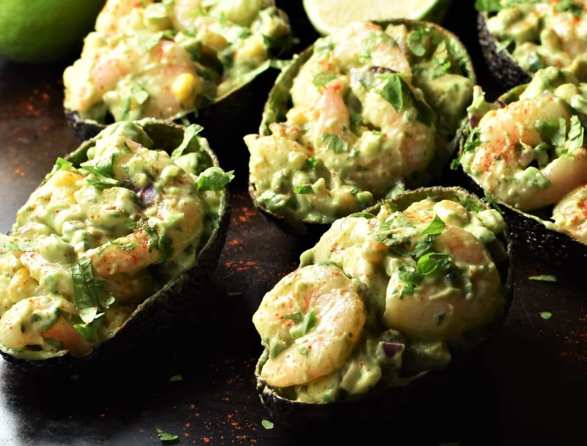 Close-up view of shrimp stuffed avocado halves.