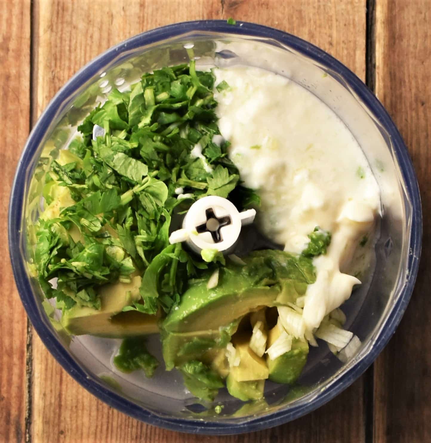 Avocado, herbs and mayonnaise in blender.