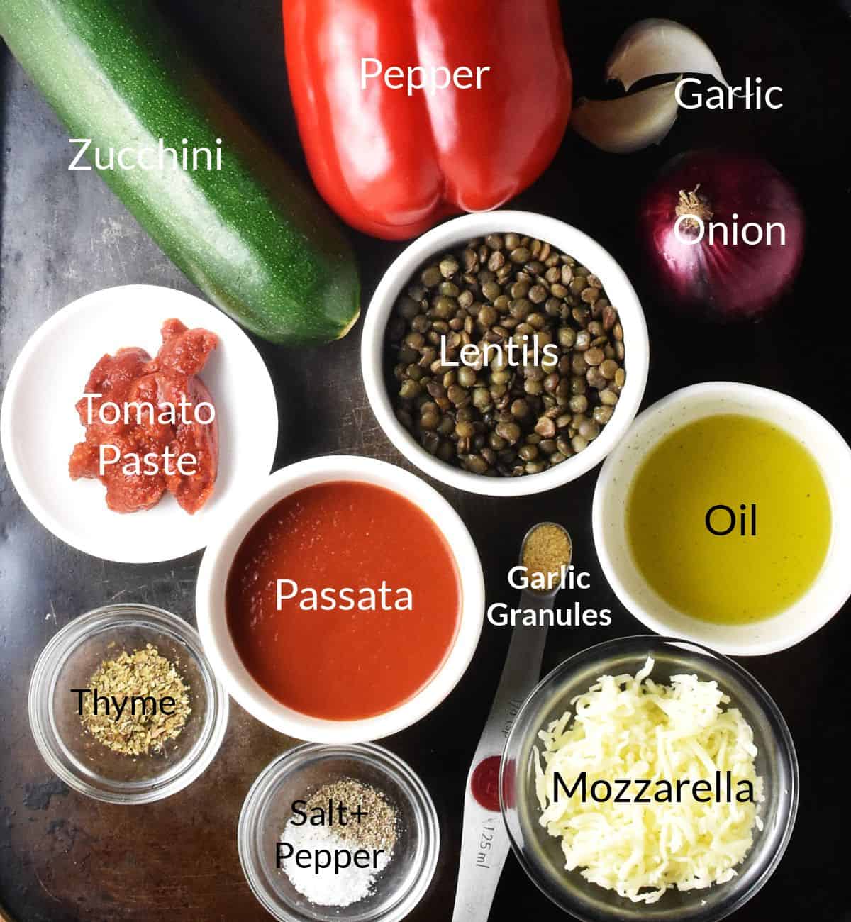 Ingredients for making vegetarian stuffed zucchini in individual dishes.