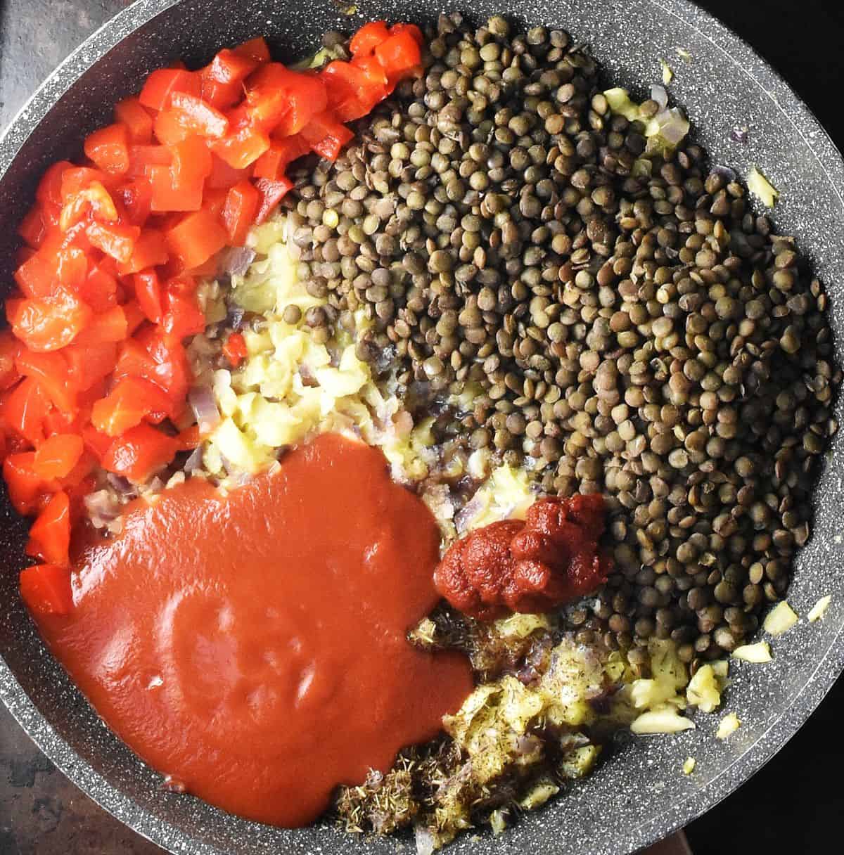 Cooked lentils, chopped red pepper and passata in large pan.