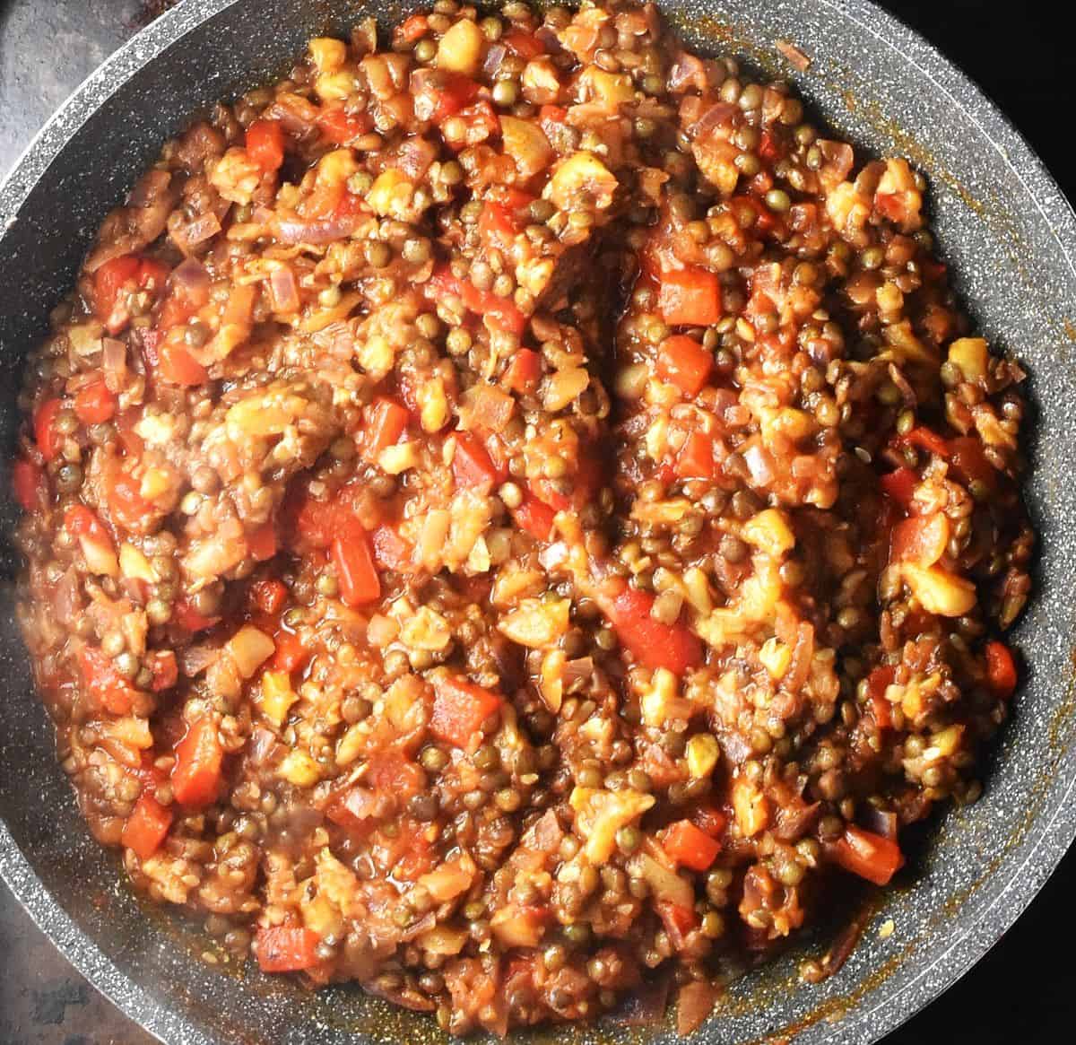 Top down view of vegetarian zucchini stuffing mixture in large pan.