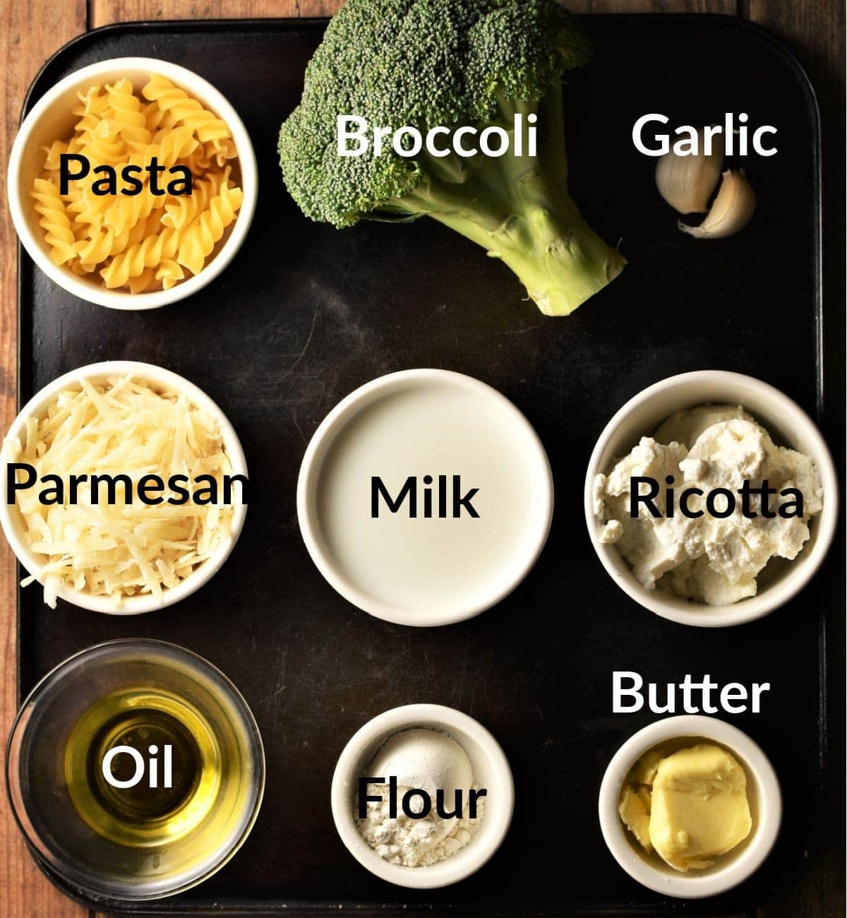 Pasta and broccoli recipe ingredients in individual dishes.