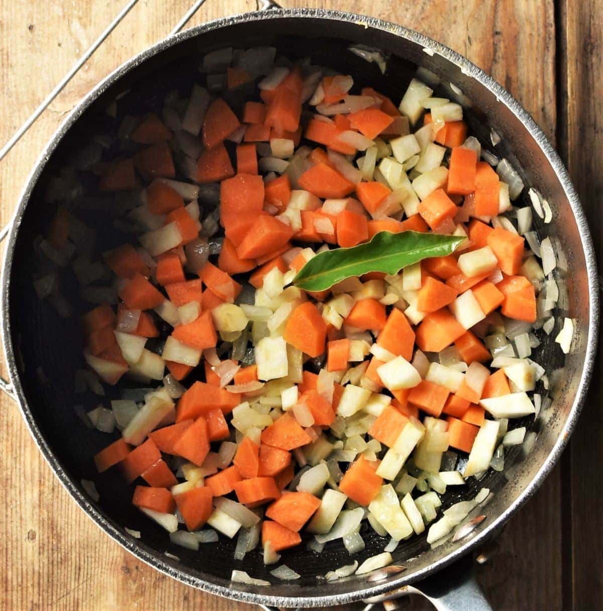 Chopped vegetables in large pot.