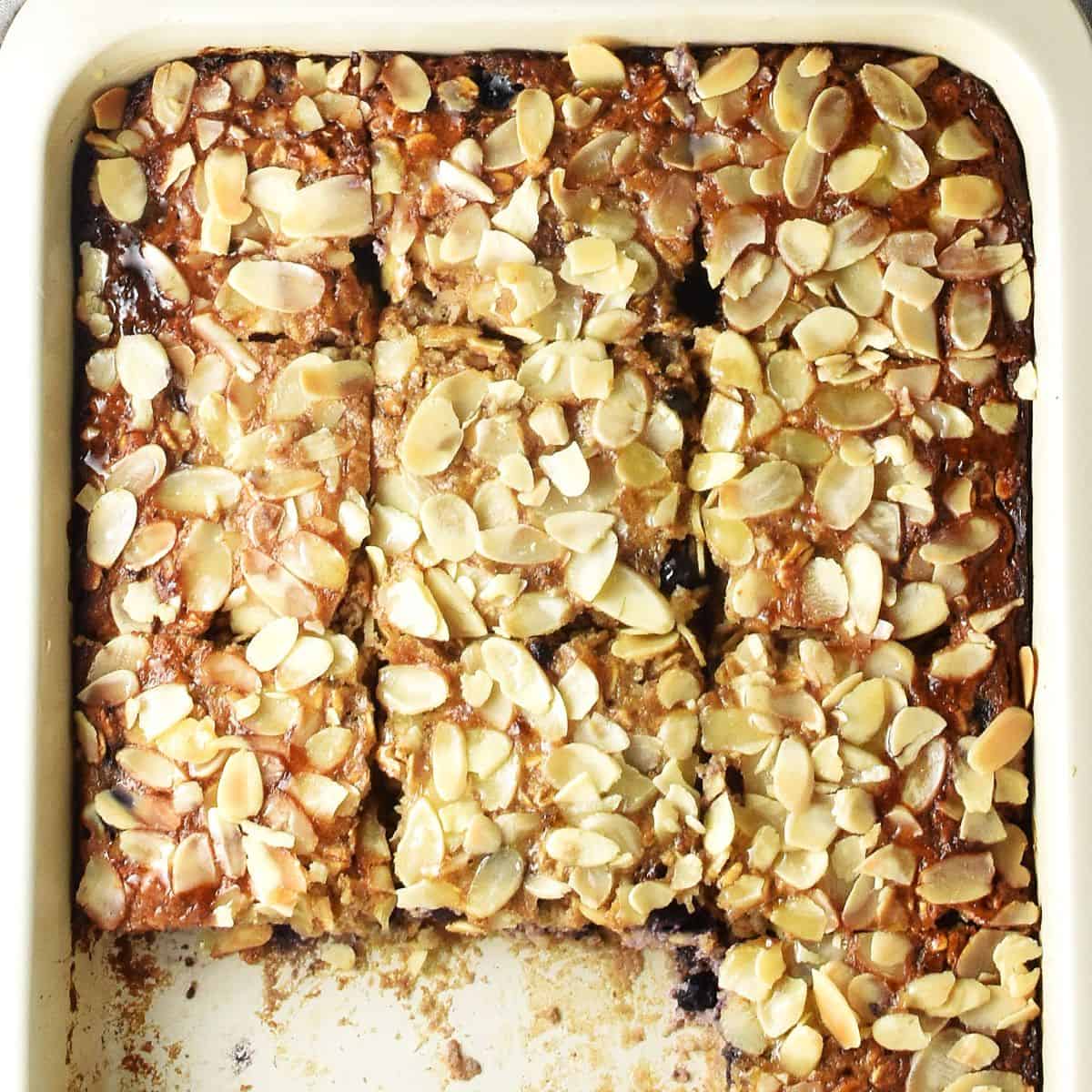 Top down view of cottage cheese oatmeal bake cut into squares in white rectangular pan.