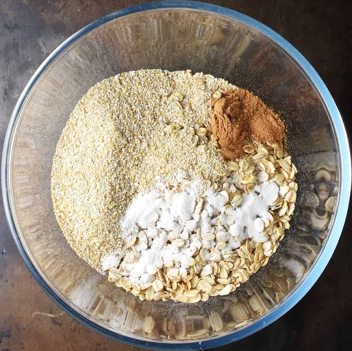 Oats and baking powder in large, glass bowl.