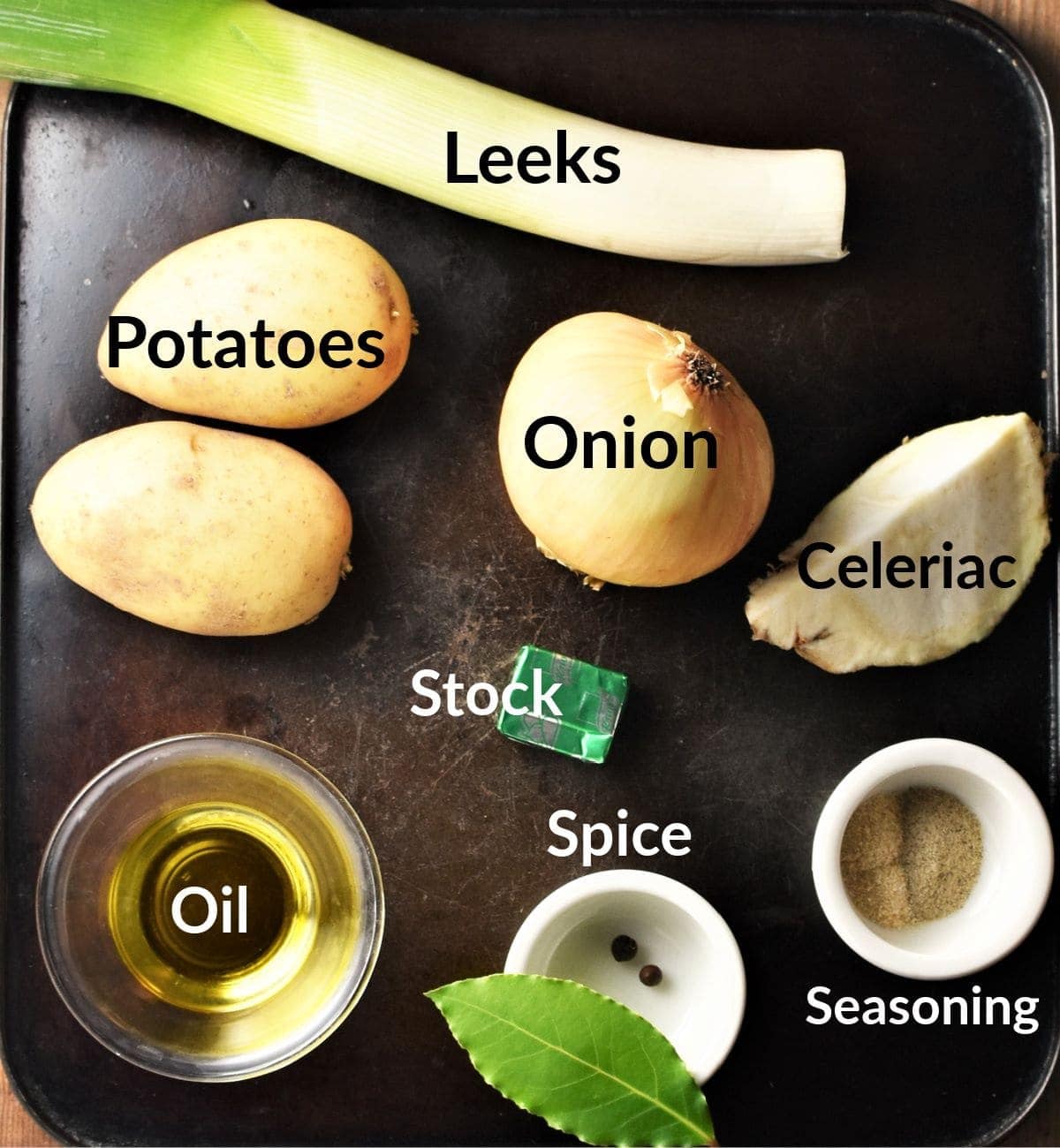 Chunky leek and potato soup ingredients in individual dishes.