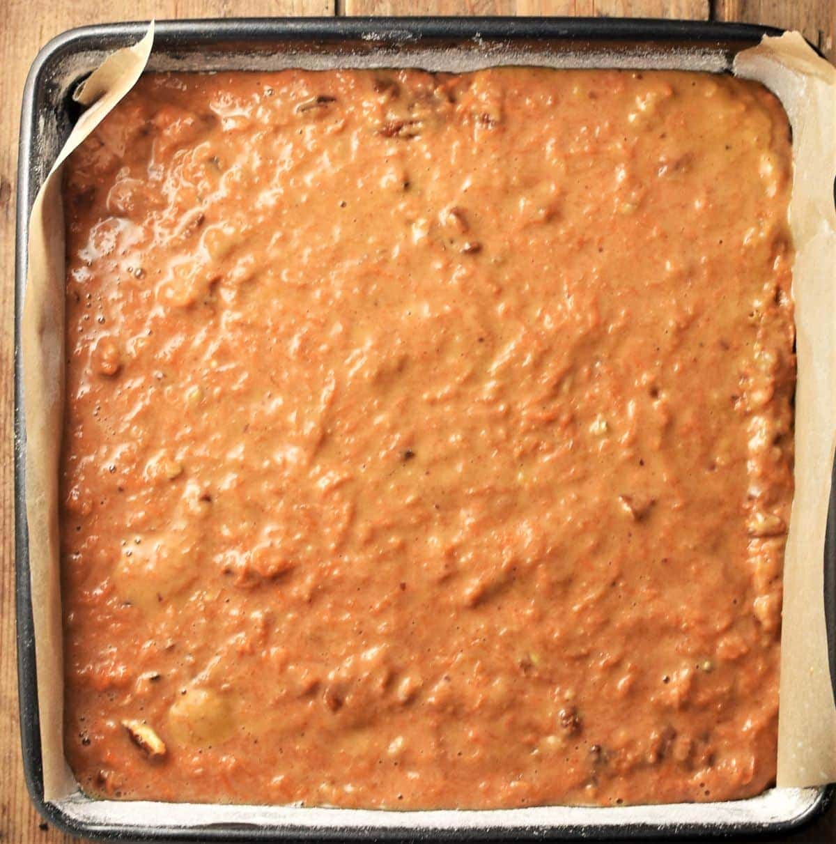 Carrot cake batter in square pan.