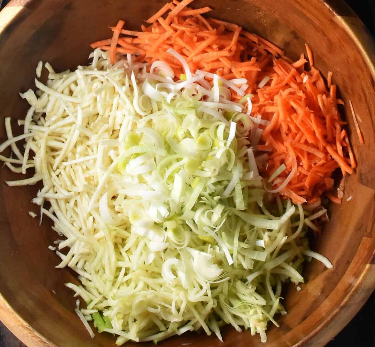Shredded vegetables in large, wooden bowl.