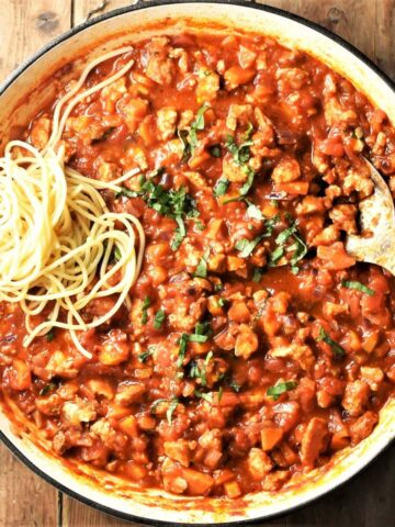 Bolognese sauce with tofu and spaghetti in large shallow pan.