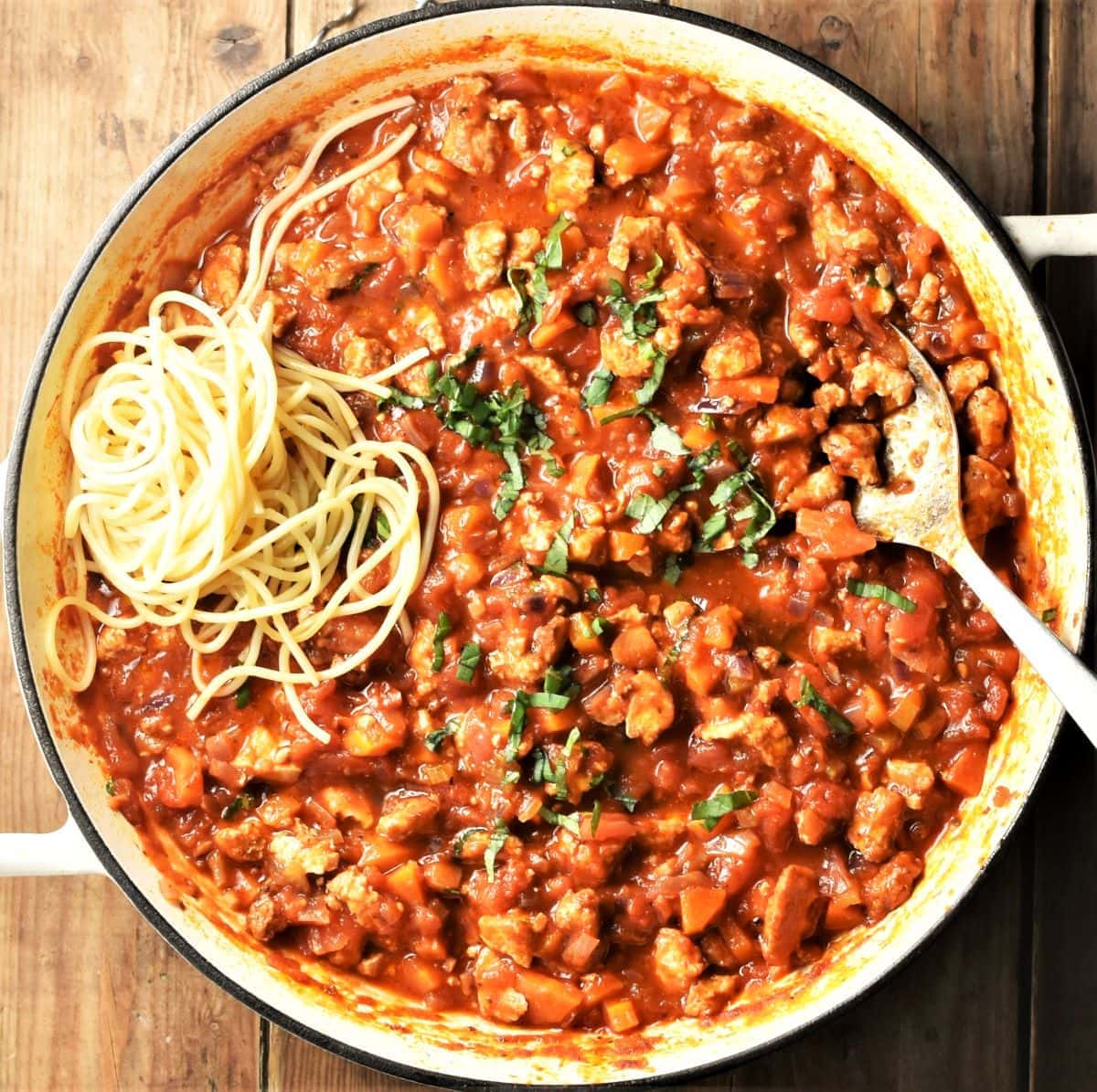 Bolognese sauce with tofu and spaghetti in large shallow pan.