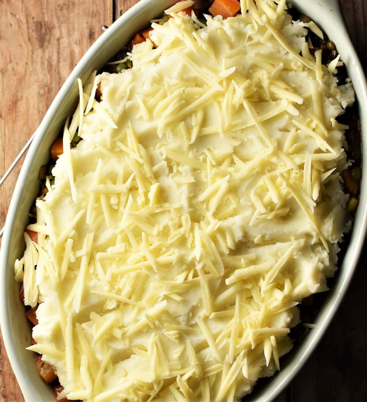 Shepherd's pie with potato topping and scatter of grated cheese.