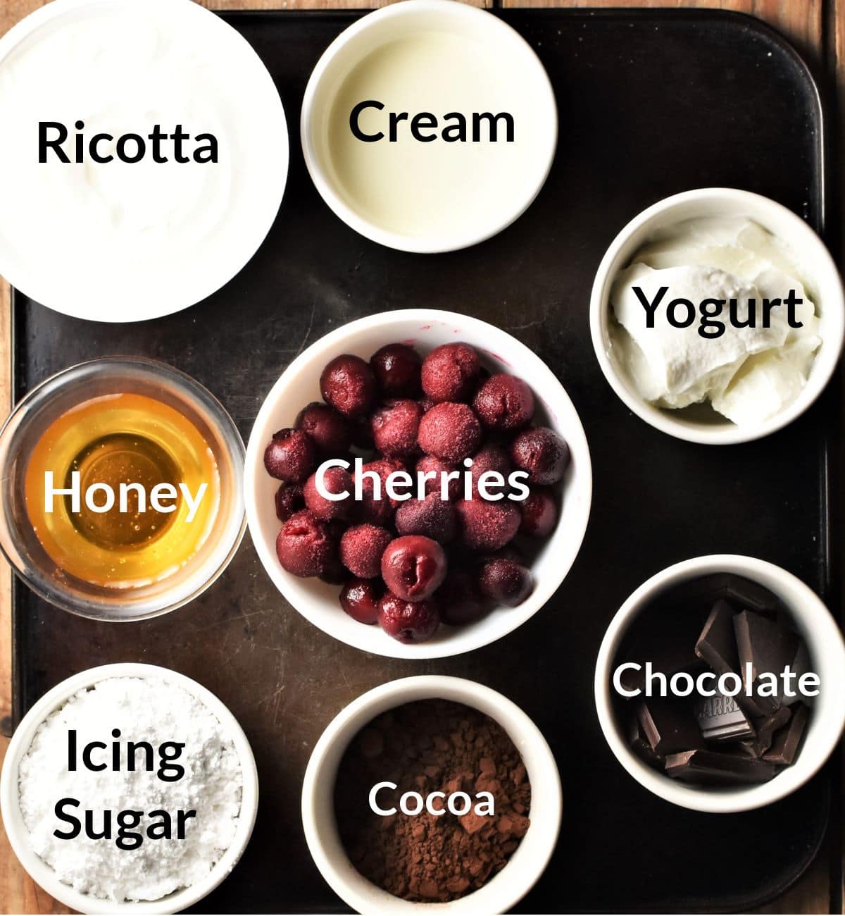 Ingredients for black forest cheesecake tart in individual dishes.