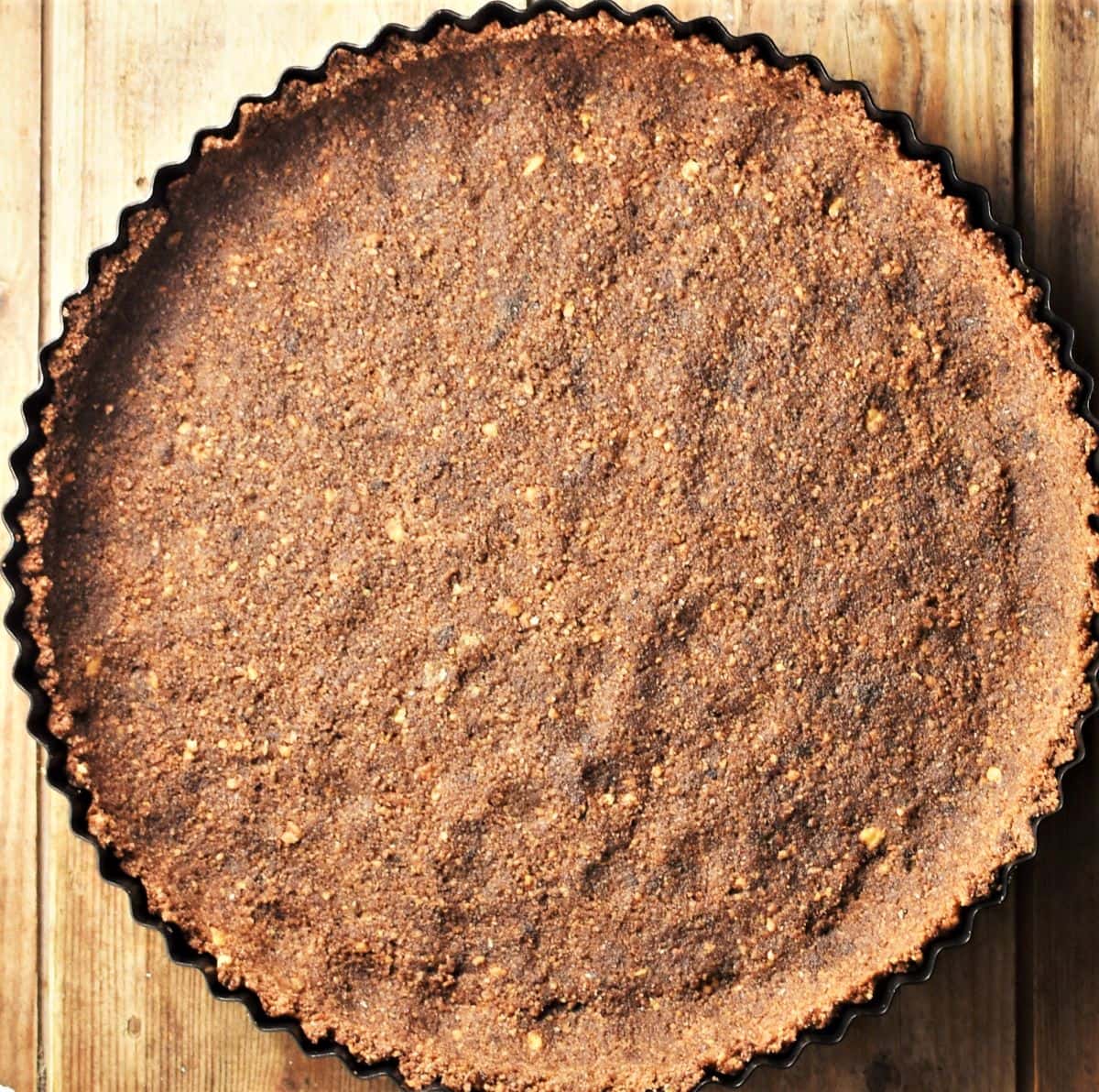 Chocolate tart base in round pan.