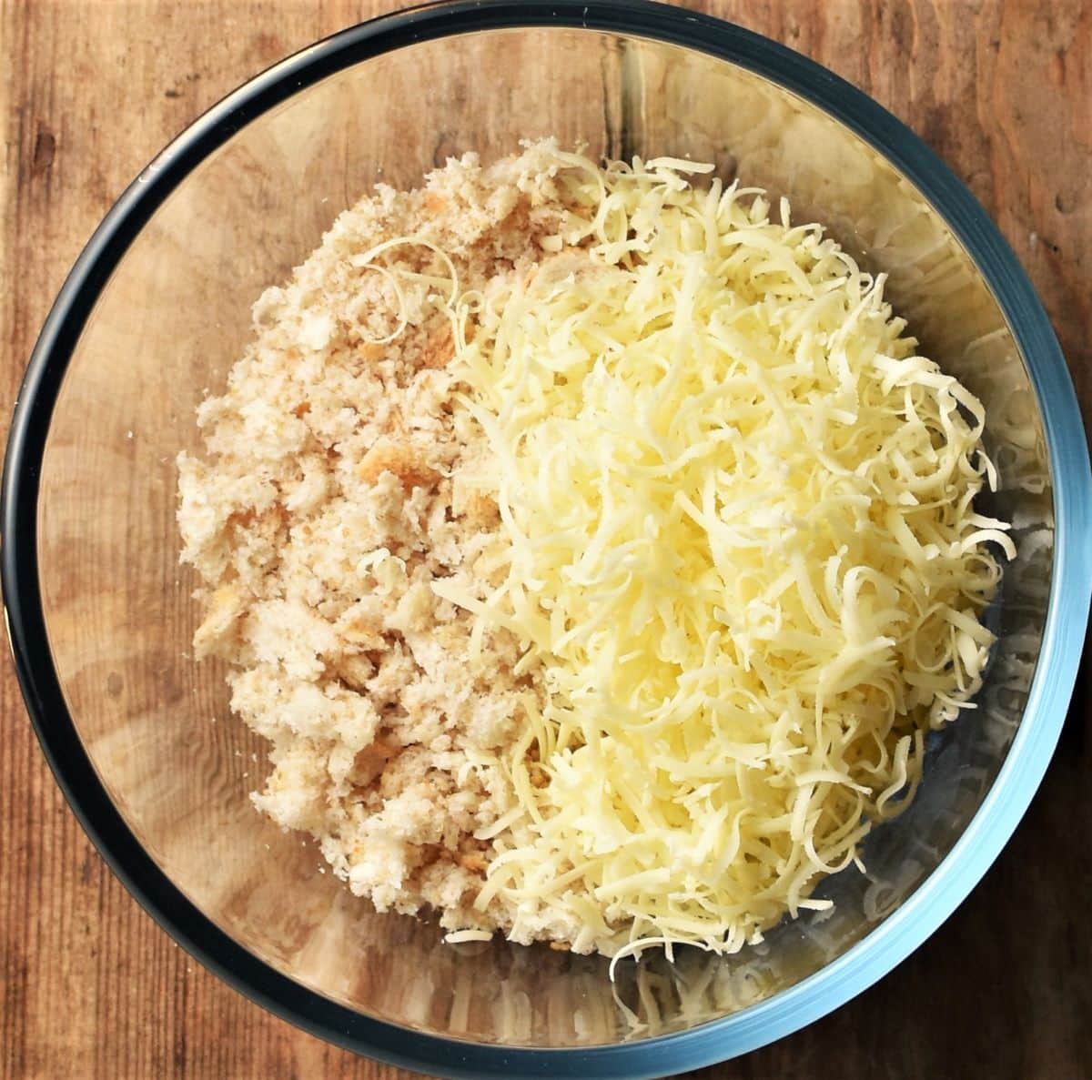 Fresh breadcrumbs with grated cheese in mixing bowl.