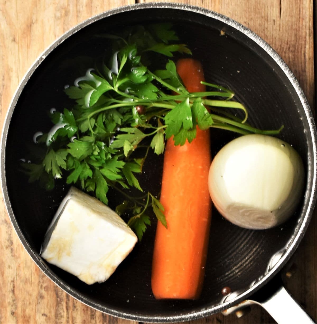 Vegetables and stock in pot.