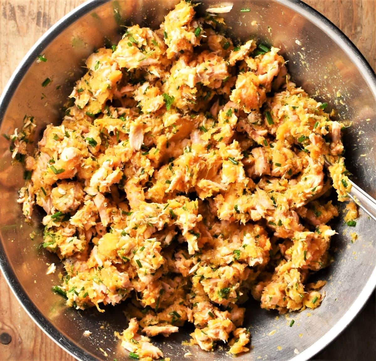 Sweet potato salmon fish cake mixture in large metal bowl.