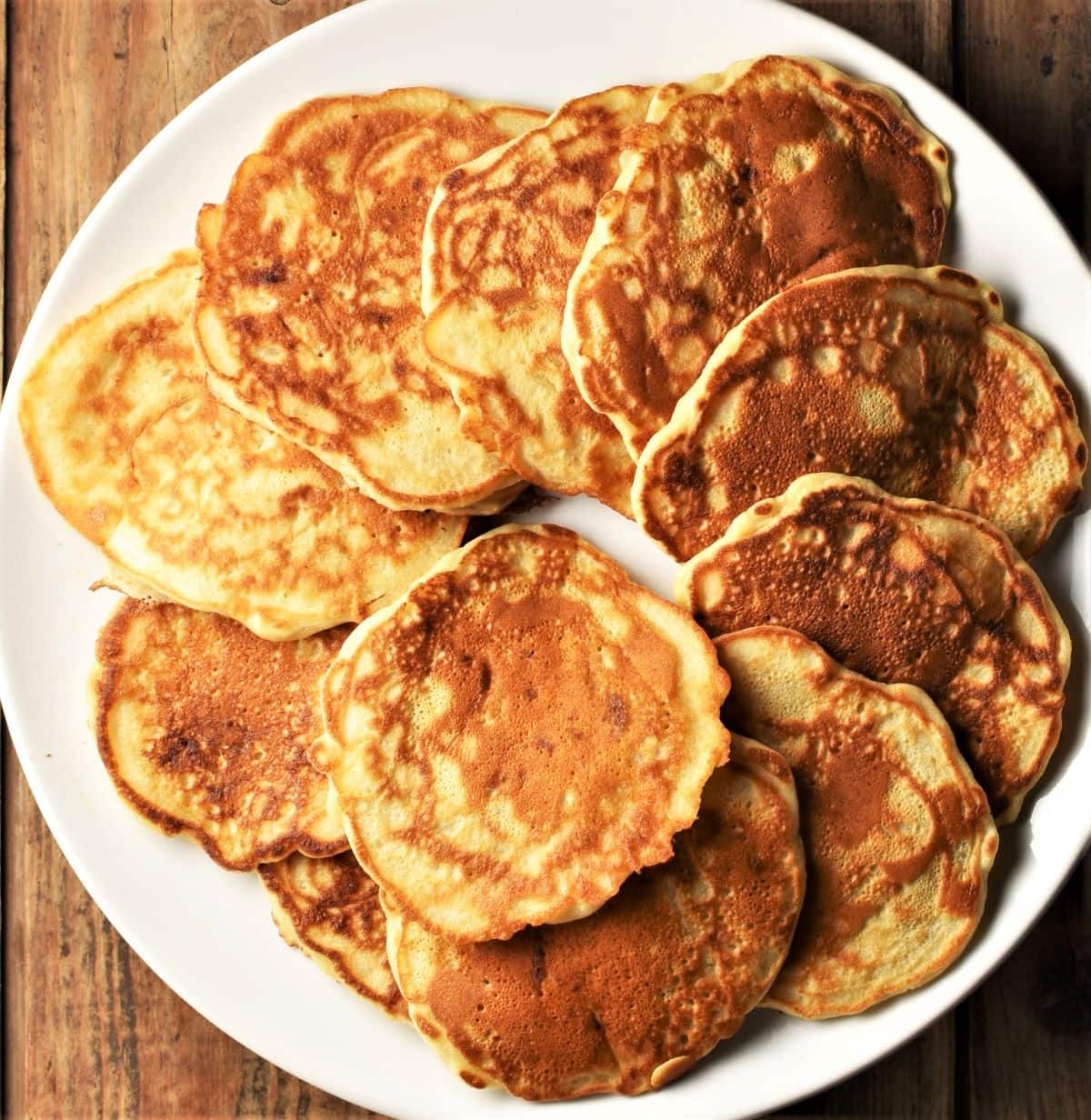 Pancakes arranged on top of large plate.