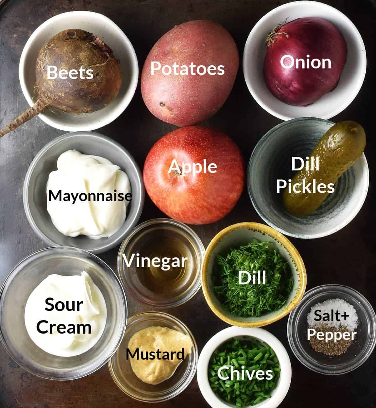 Top down view of ingredients for potato beet salad in small, labelled dishes.