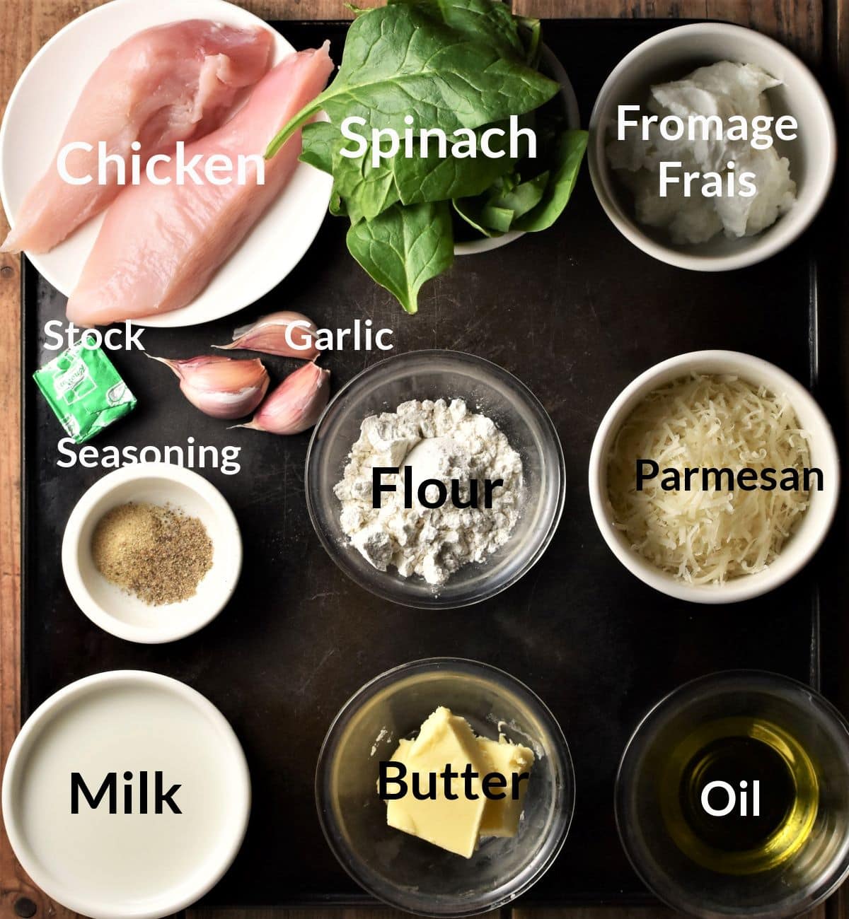 Ingredients for making creamy spinach chicken recipe in individual dishes.
