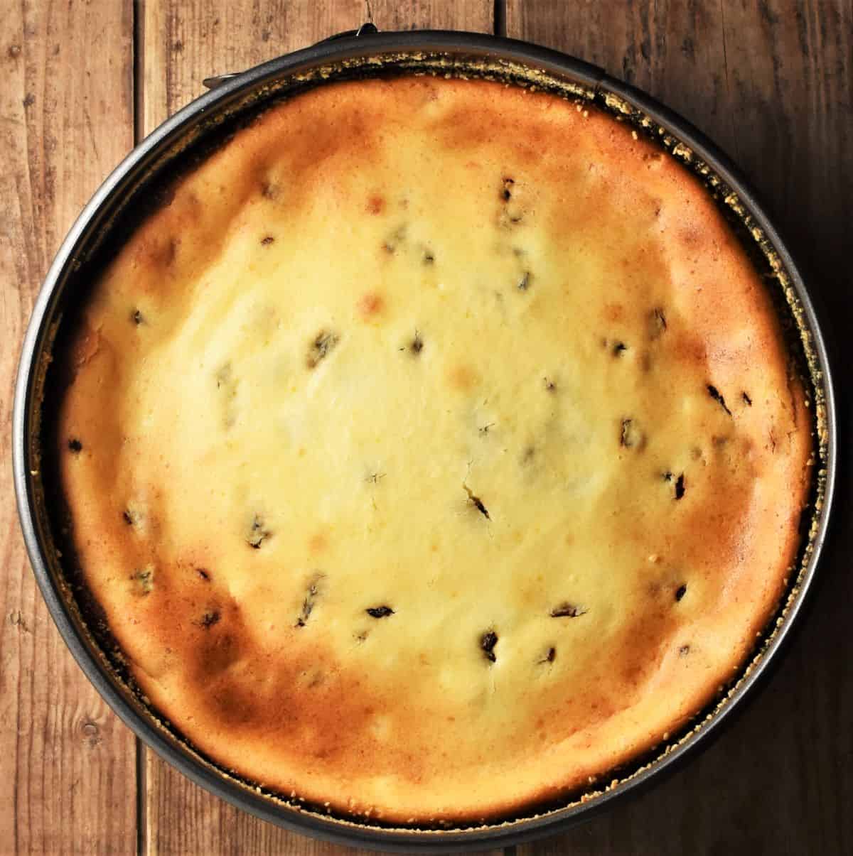 Top down view of baked Polish sernik in round pan.