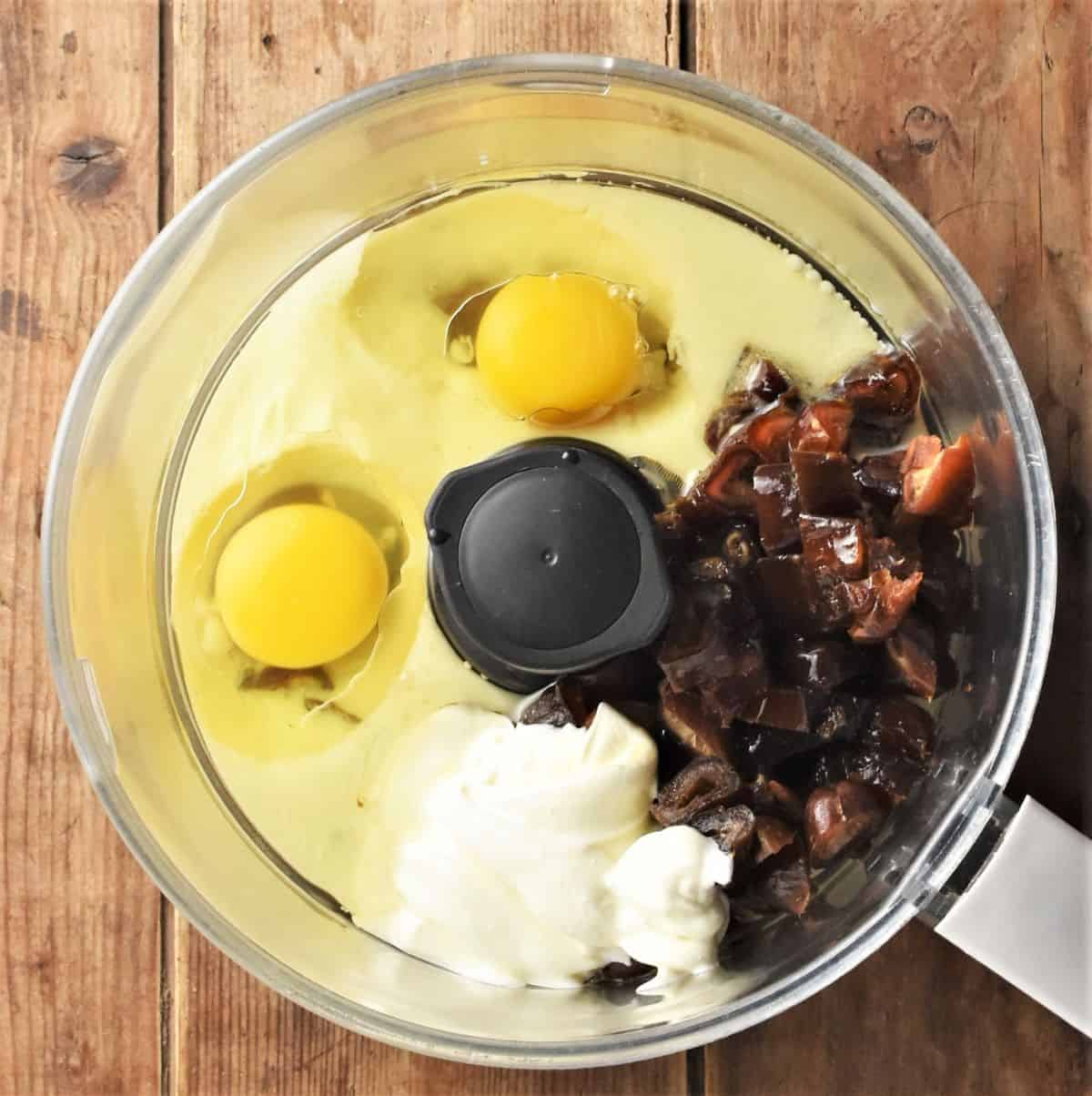 2 eggs, milk, sour cream, chopped dates and oil in food processor bowl.