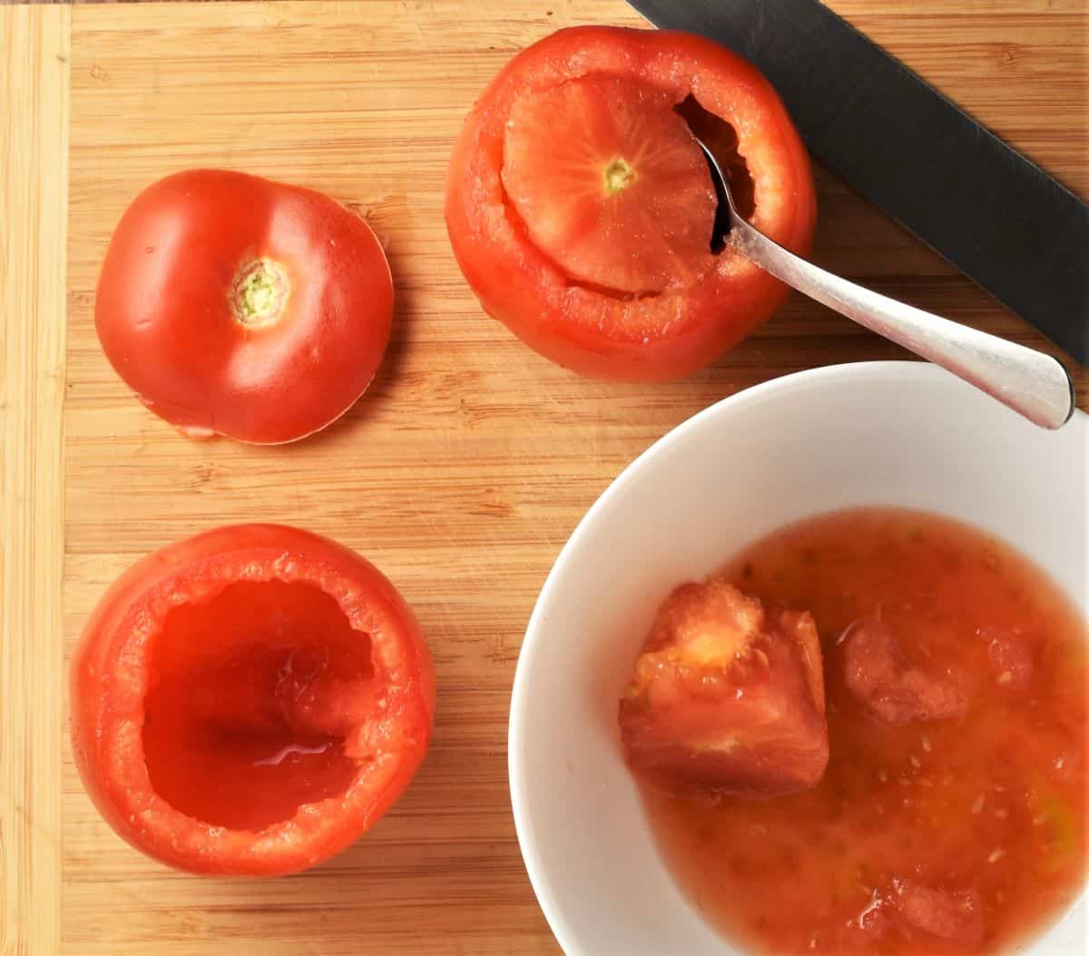 Hollowing out tomatoes for stuffing.