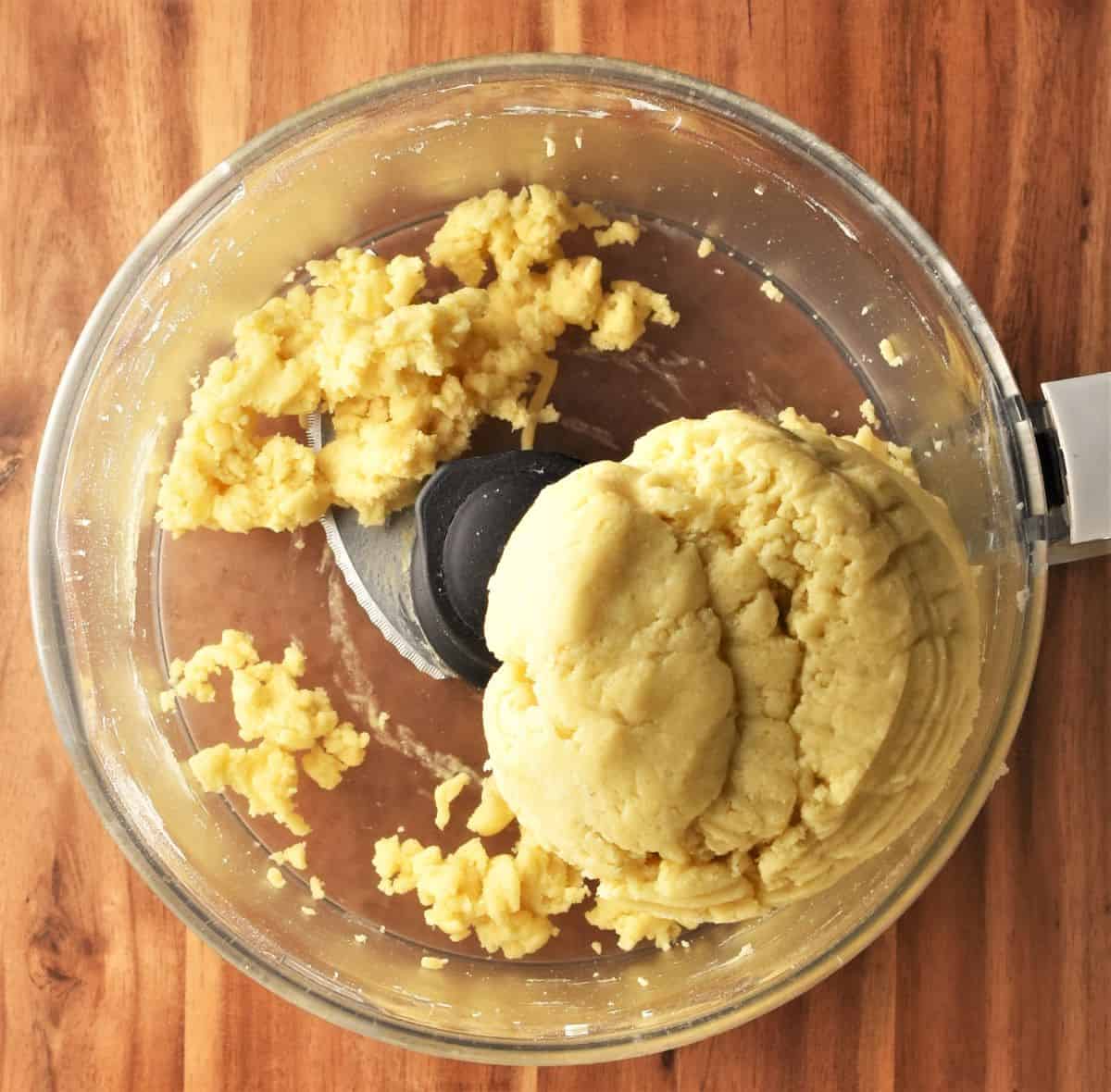 Cake dough in bowl of food processor.