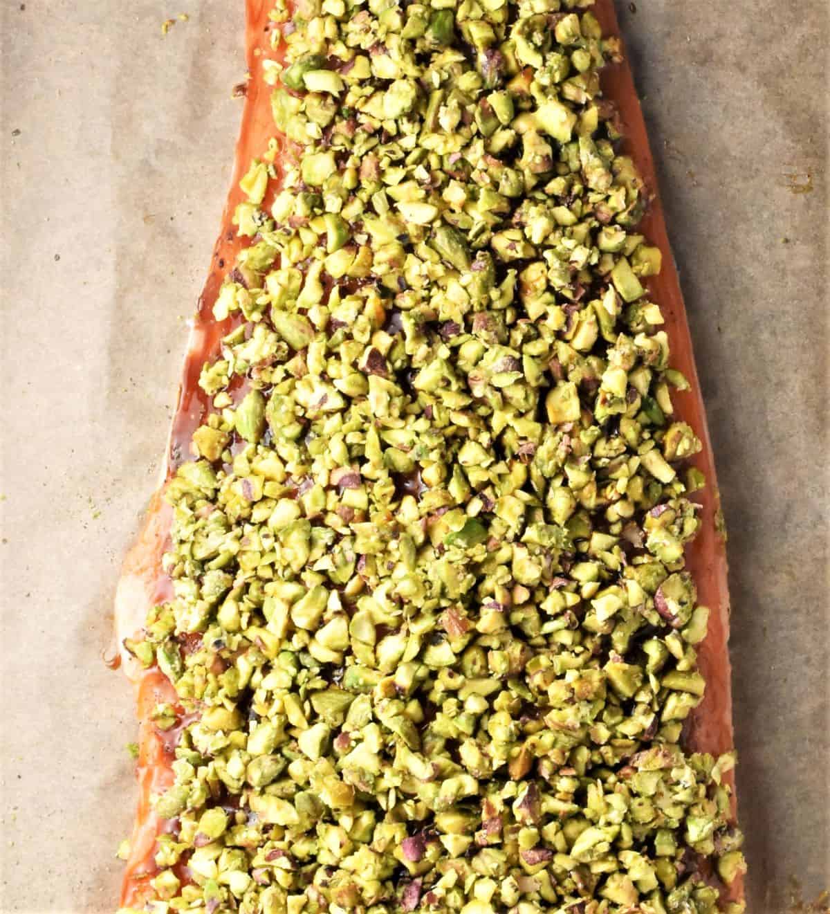 Salmon side with chopped pistachios on top.