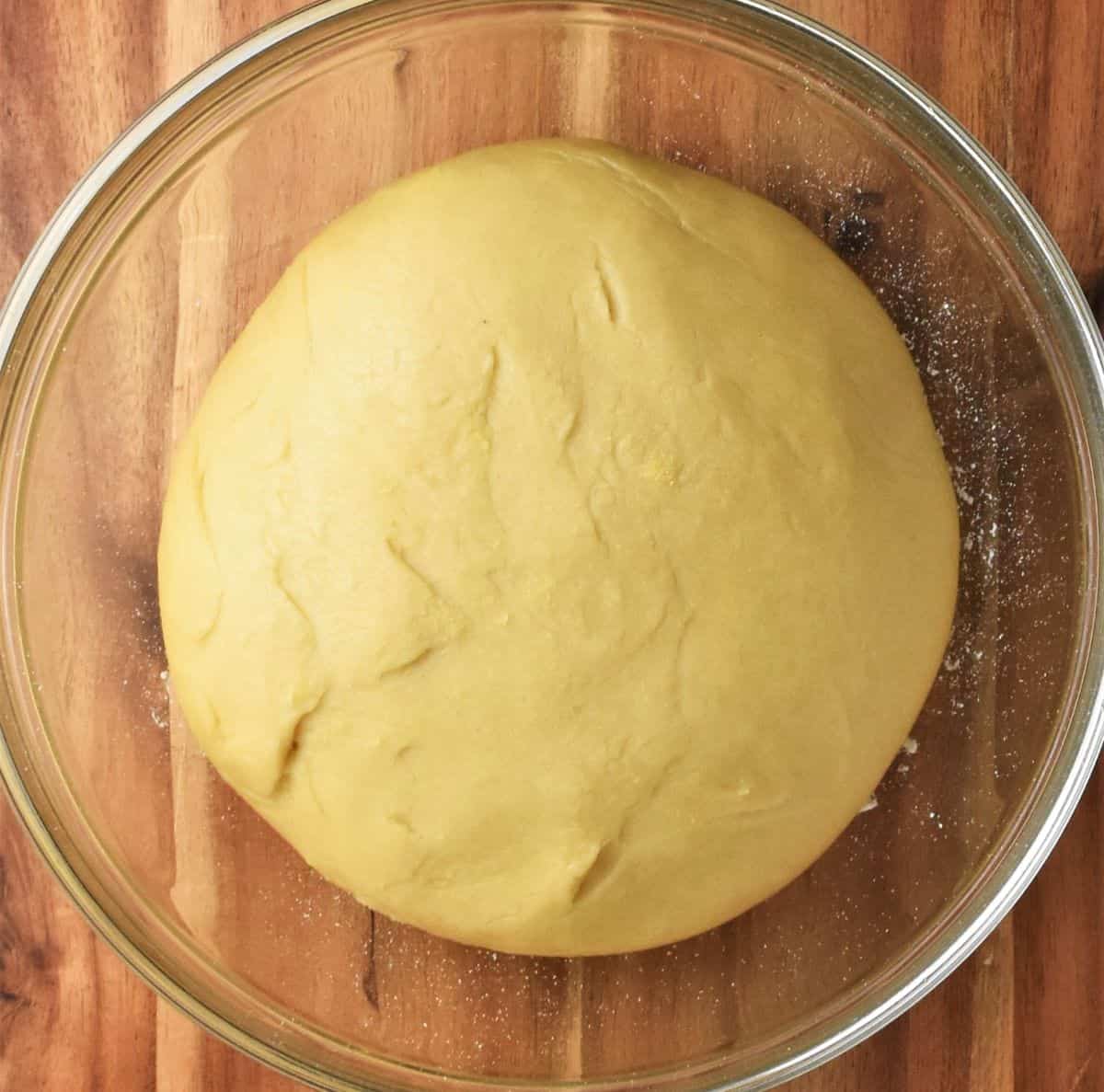 Proofed dough for cake in glass bowl.