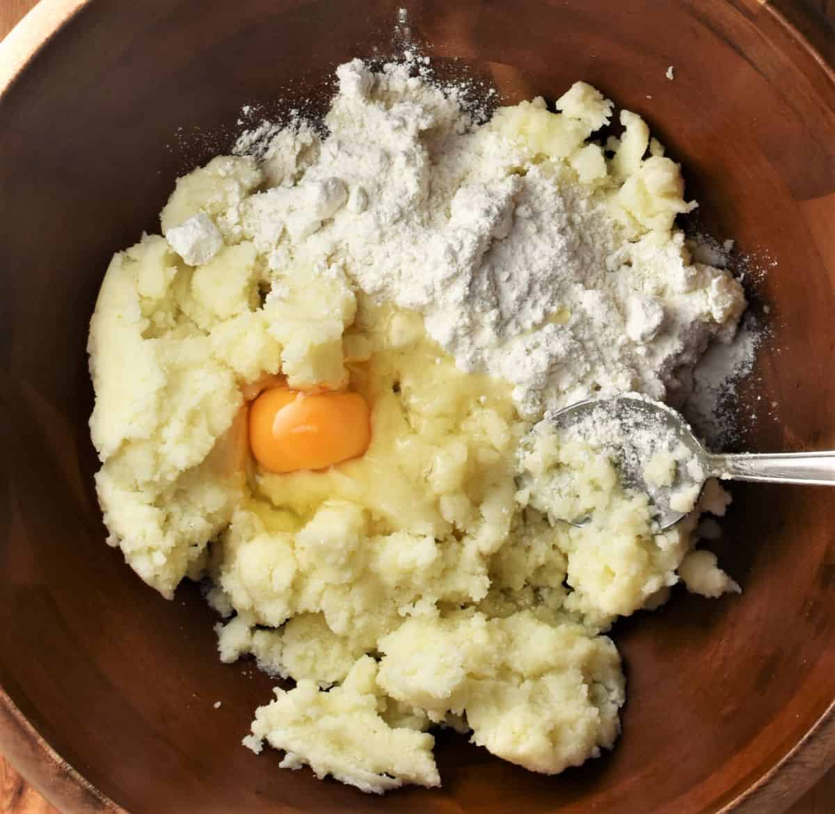 Polish potato dumpling ingredients in large wooden bowl.