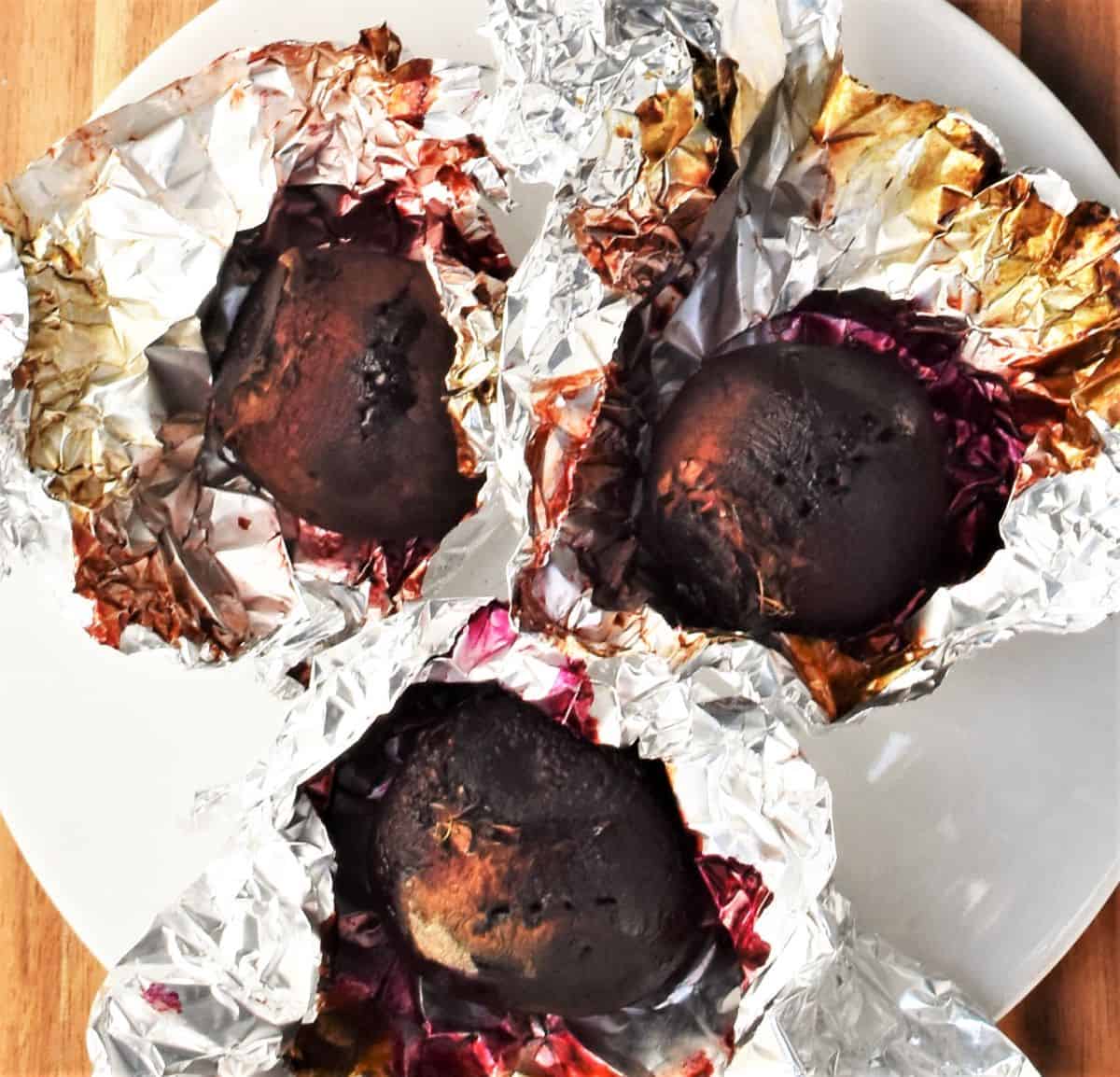 Roasted beets partly wrapped in foil.