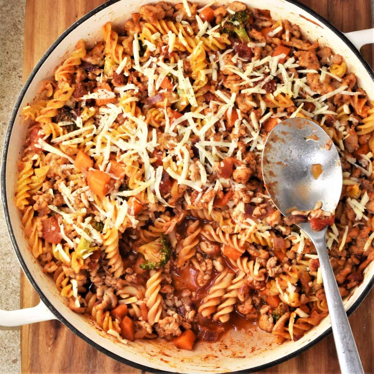 Top down view of ground chicken casserole in large round dish with spoon.