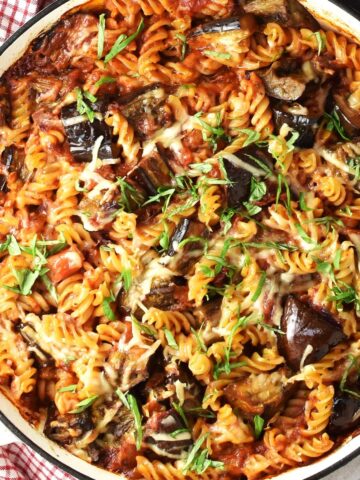 Top down view of eggplant pasta bake in shallow round pan.