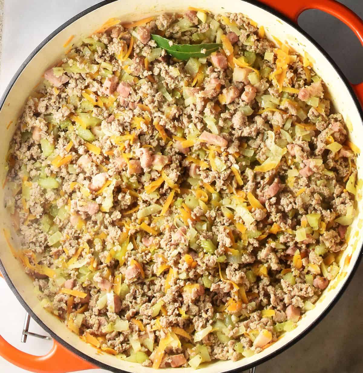 Top down view of ground turkey and vegetable mixture in large pan.