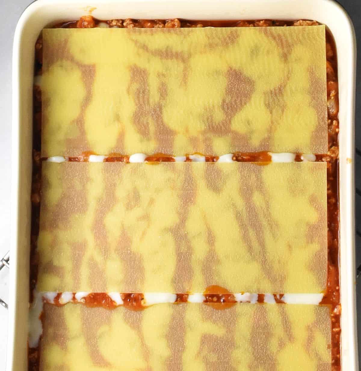 Lasagne pasta layer in rectangular dish.