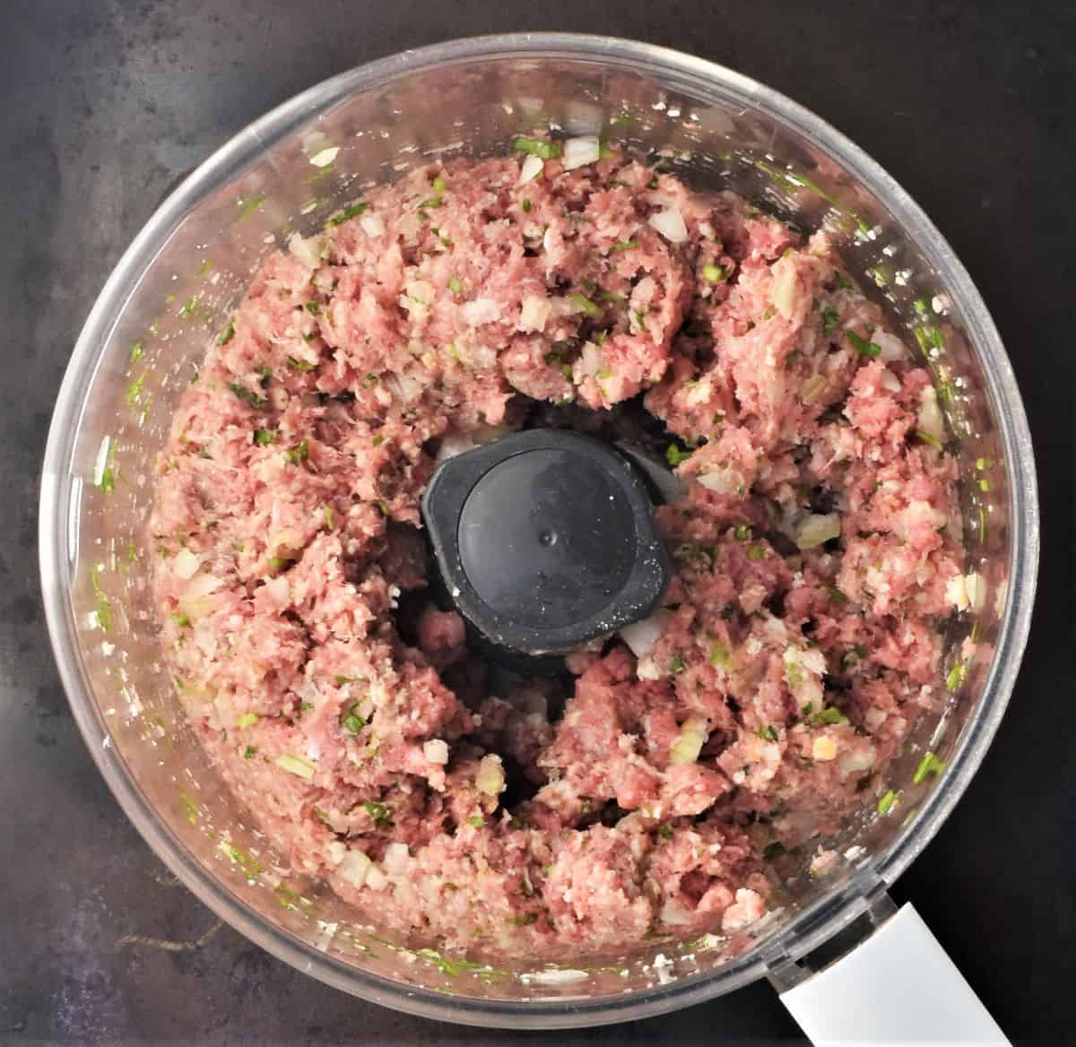 Meatball mixture in blender bowl.