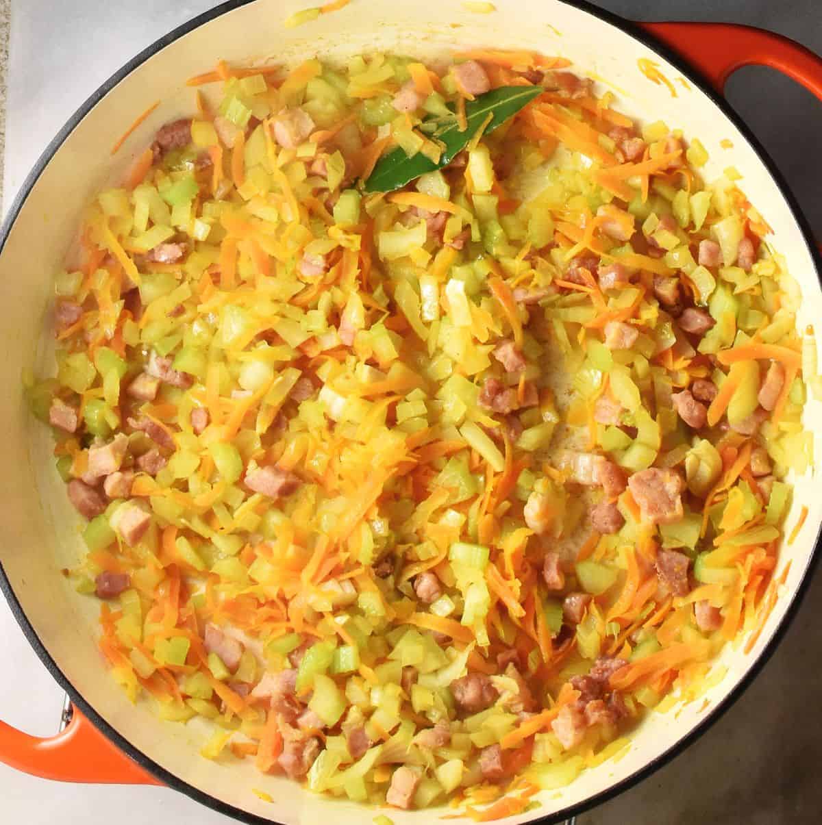 Top down view of finely chopped vegetables in round white pan.