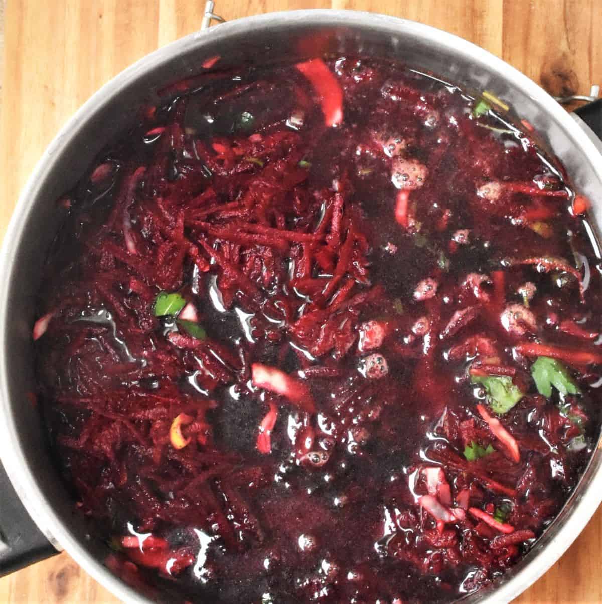 Top down view of vegetarian borscht soup in large pot.