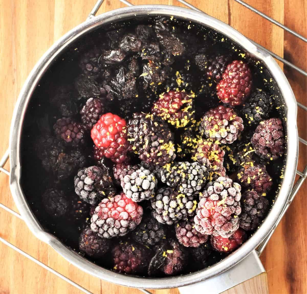 Frozen blackberries inside saucepan.