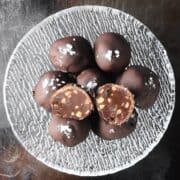 Top down view of peanut butter chocolate truffles in glass bowl.