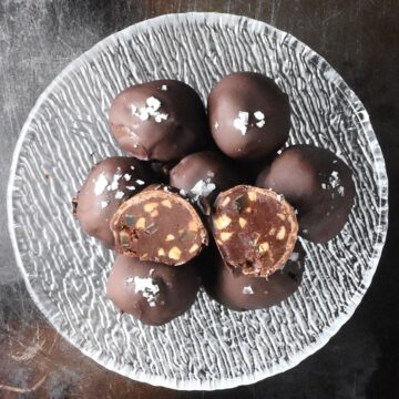 Top down view of peanut butter chocolate truffles in glass bowl.
