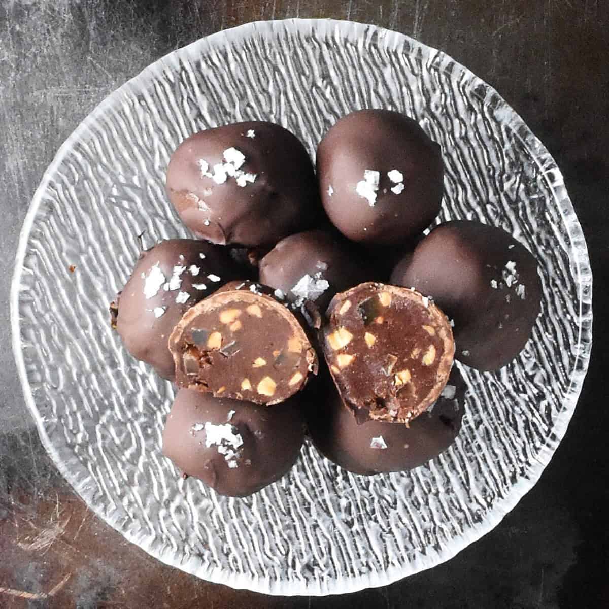 Top down view of peanut butter chocolate truffles in glass bowl.
