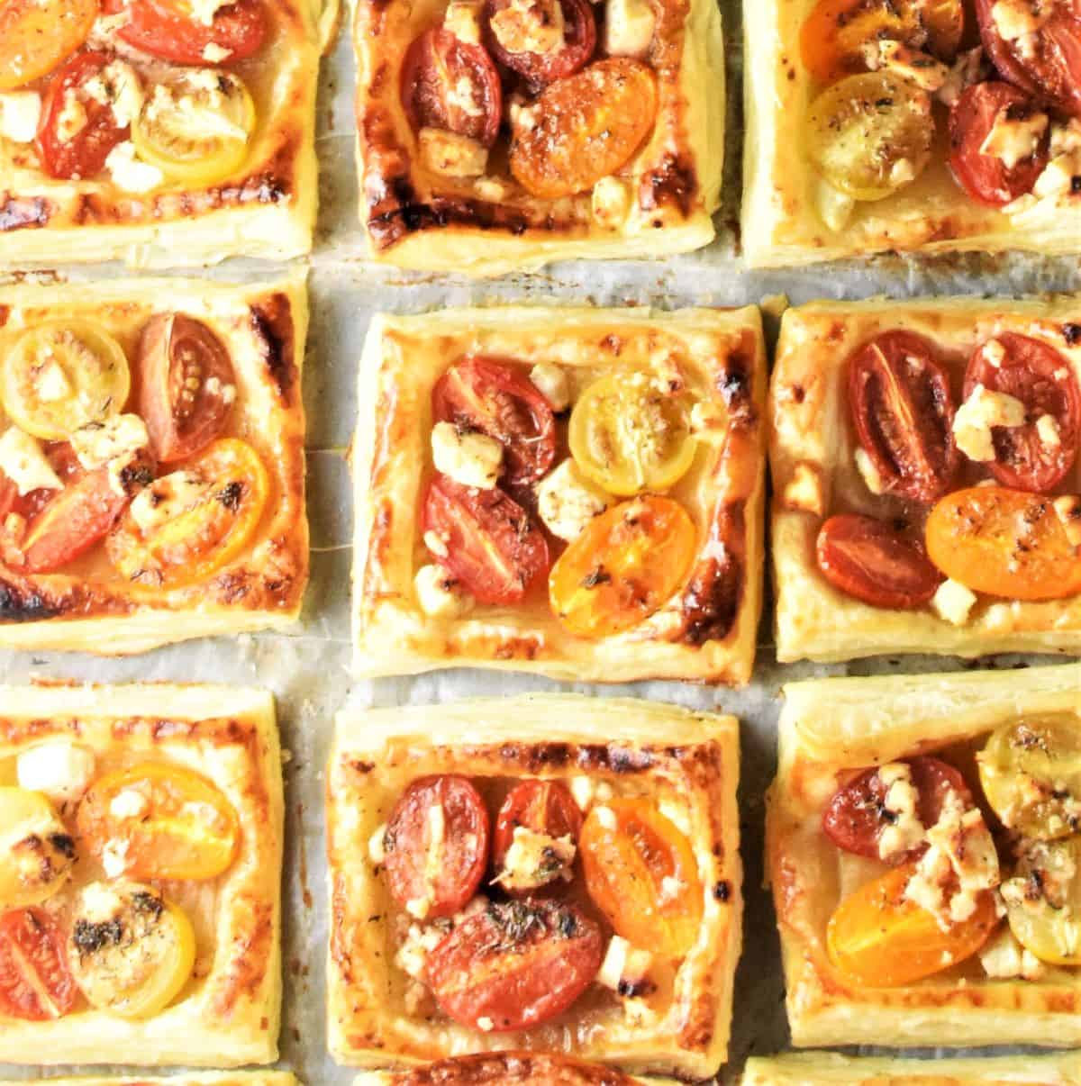 9 tomato tartlets with feta on parchment.