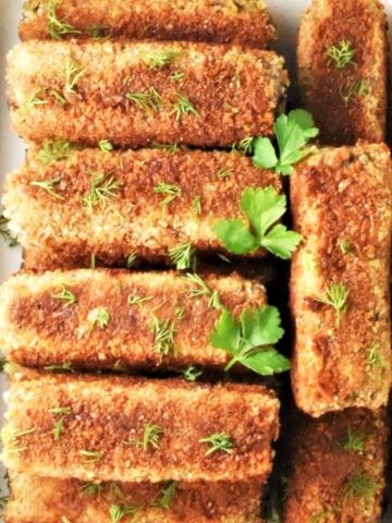 Top down view of mushroom croquettes in ceramic dish.